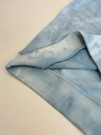 Light blue tie-dye sweatshirt sleeve with ribbed cuff detail