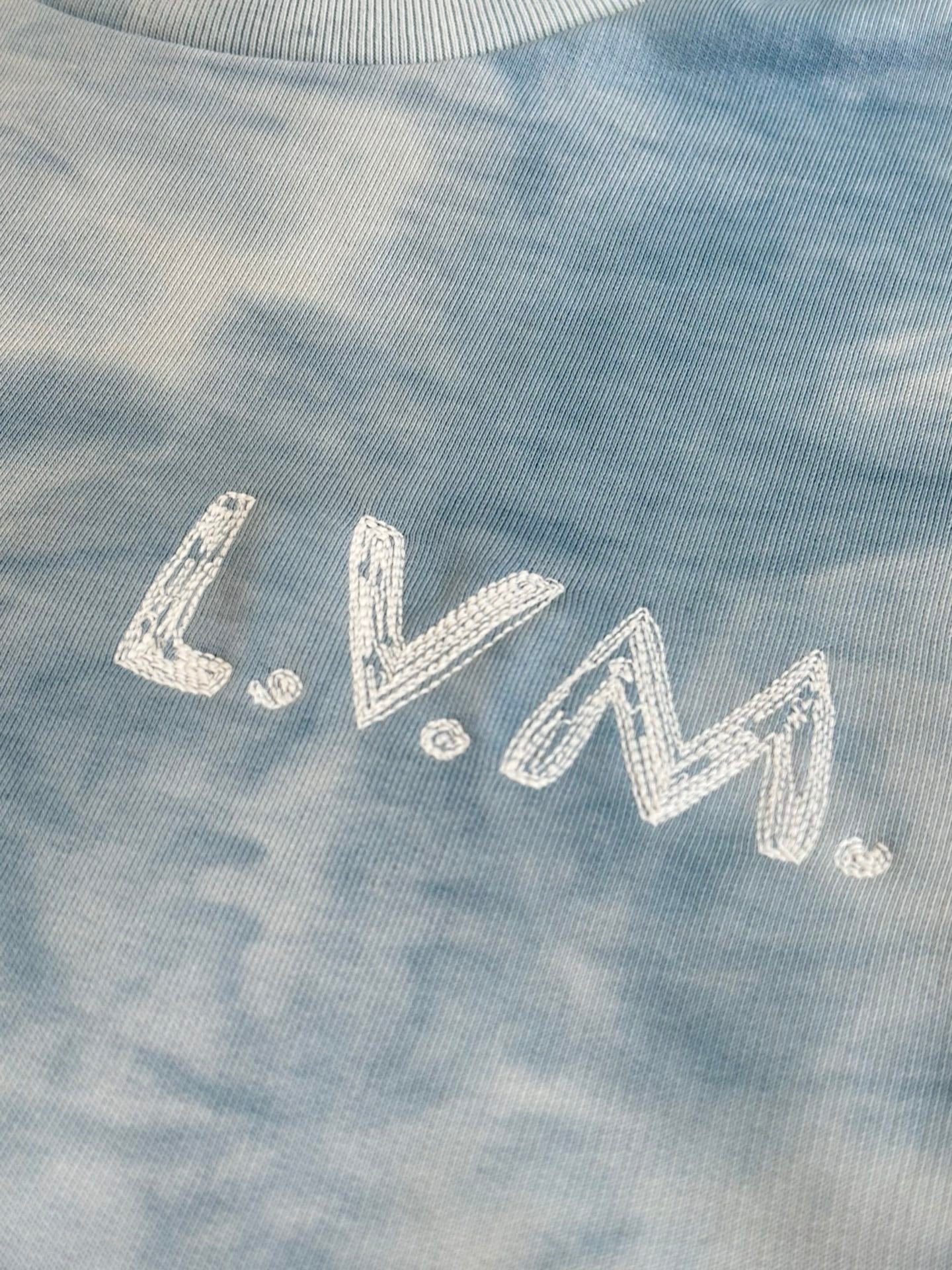Light blue tie-dye sweatshirt with rhinestone-style logo lettering