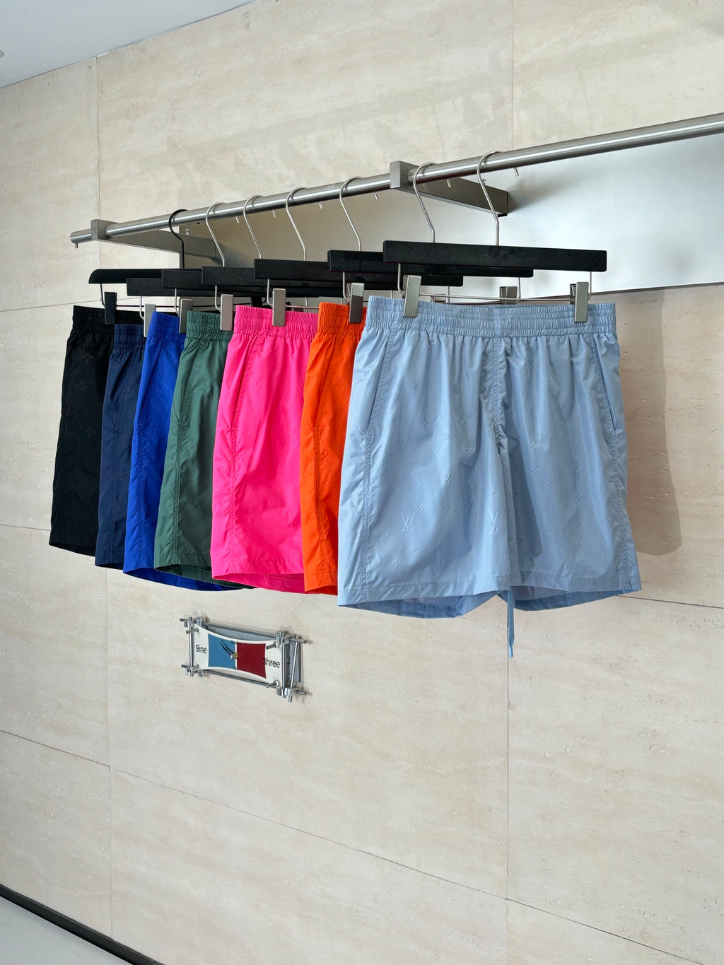 Set of monogram shorts in multiple colors, including light blue