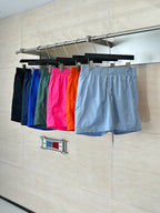 Set of monogram shorts in multiple colors, including light blue