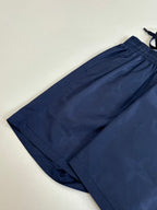 Navy shorts folded view with elastic waistband and tonal monogram pattern