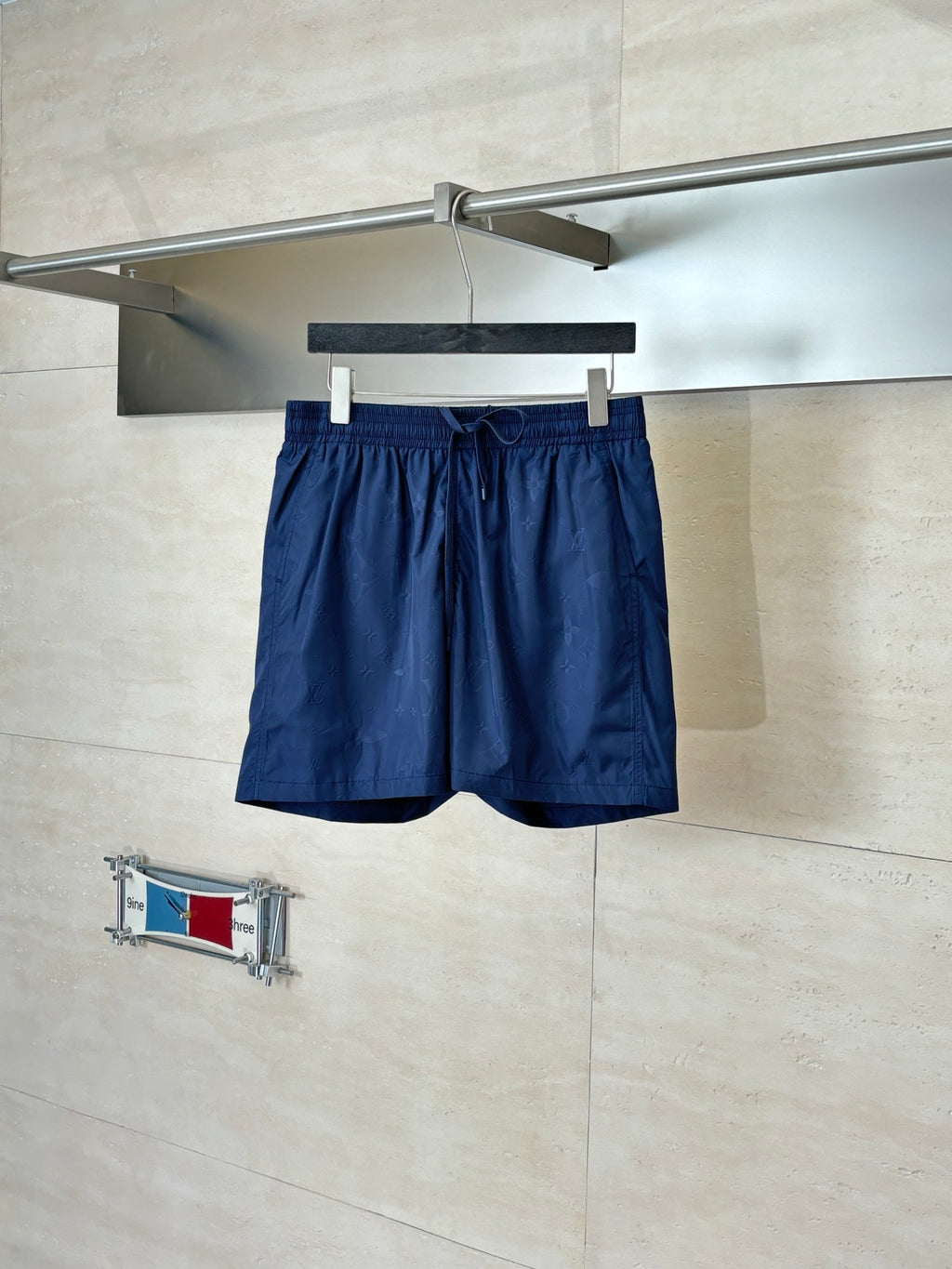 Navy drawstring shorts with elastic waistband and side pleats