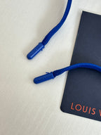 Blue drawstring and Louis Vuitton tag on blue shorts