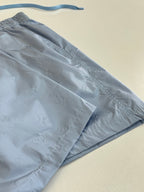 Light blue monogram shorts fabric close-up with side seam