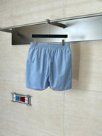 Light blue monogram shorts hanging view with elastic waistband