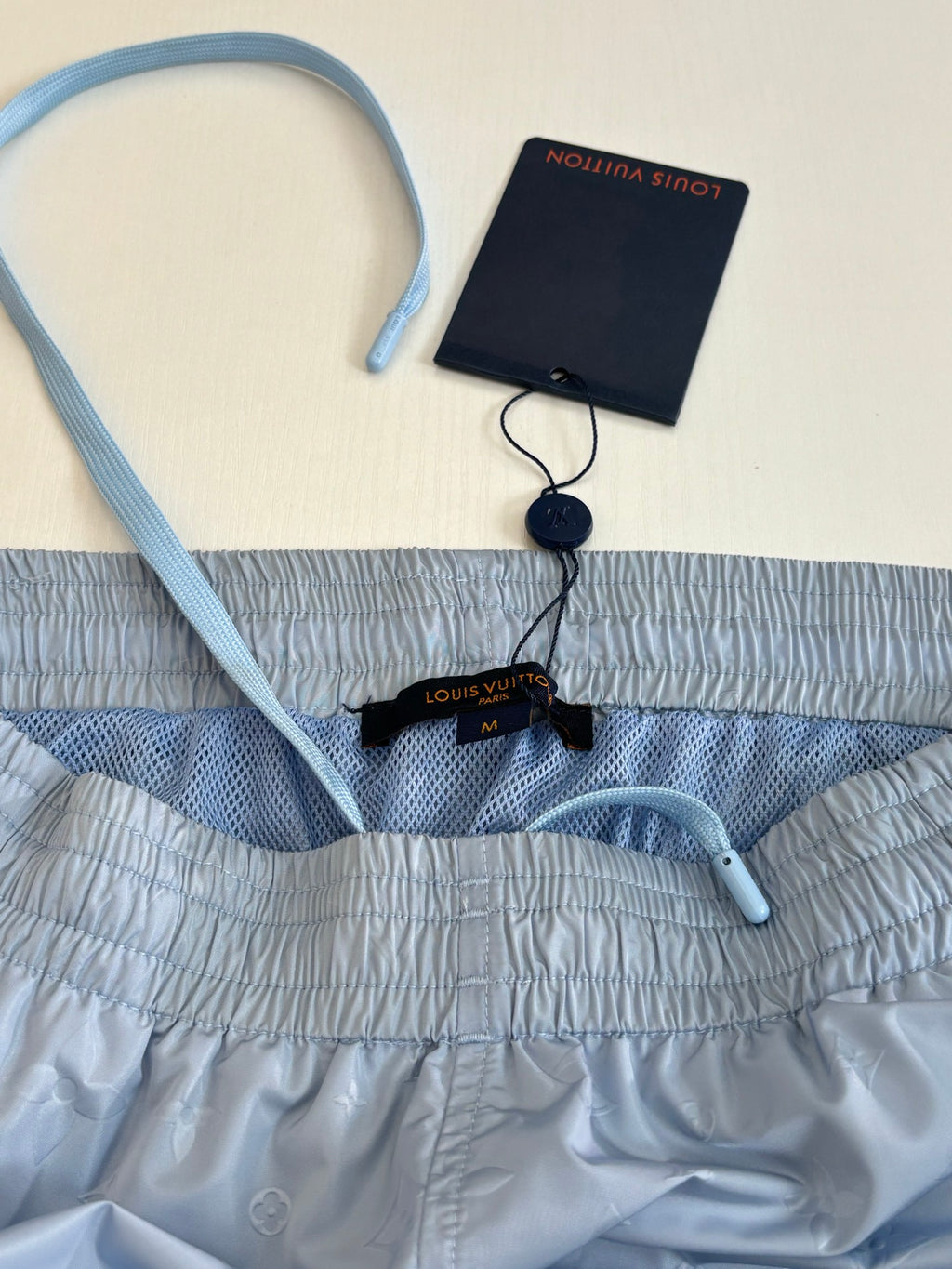 Light blue monogram shorts with waistband, drawstring, and Louis Vuitton label