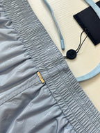 Light blue monogram shorts detail with ruched waistband and zip pocket