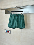 Green Louis Vuitton drawstring shorts with elastic waistband, short length.