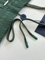 Green Louis Vuitton drawstring tips and navy hang tag on shorts.