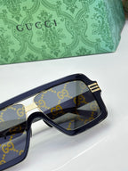 Gucci glasses close-up on side frame with gold trim and GG logo lenses