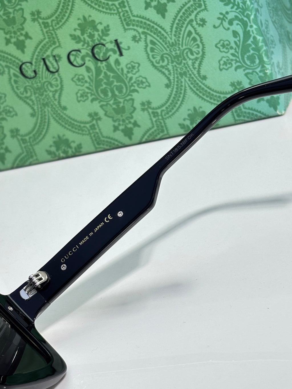 Gucci glasses close-up of temple with Gucci text and metal hardware