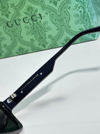 Gucci glasses close-up of temple with Gucci text and metal hardware
