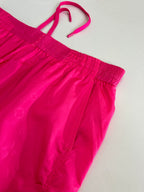Pink off-shoulder style shorts top view with elastic waist and drawstring