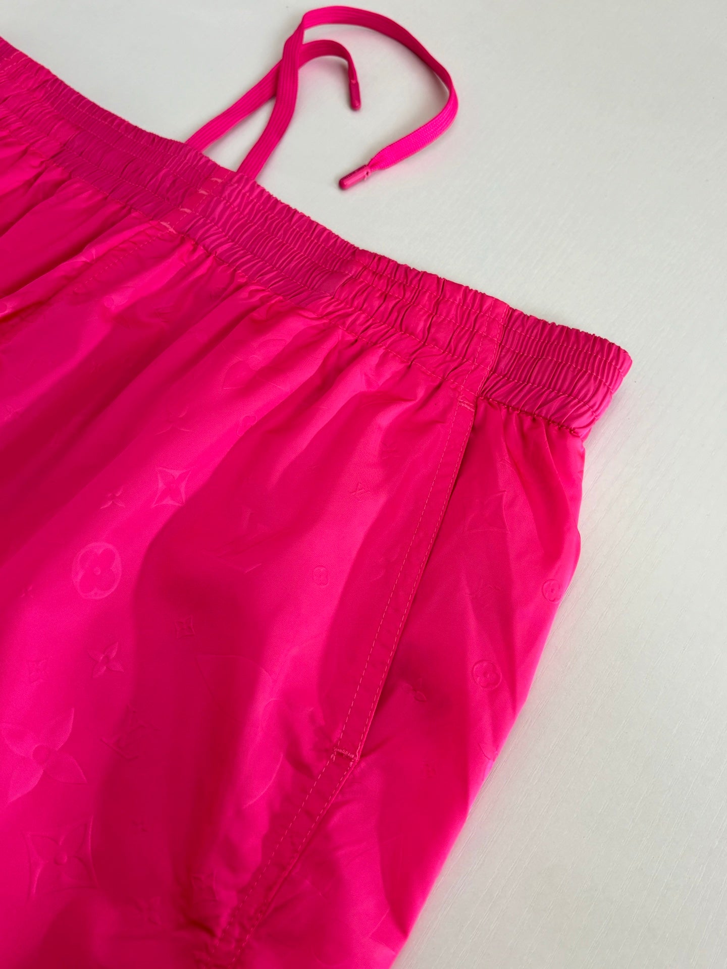 Pink off-shoulder style shorts top view with elastic waist and drawstring
