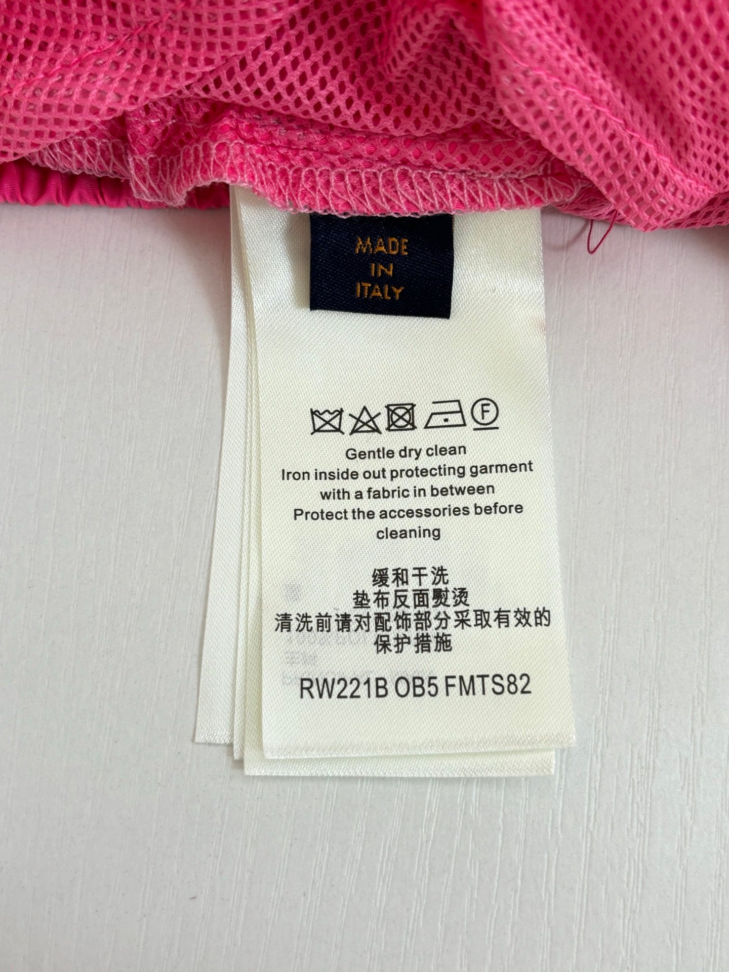 Pants care label with Made in Italy and cleaning instructions