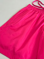 Hot pink shorts fabric with elastic waistband and curved side panel seams