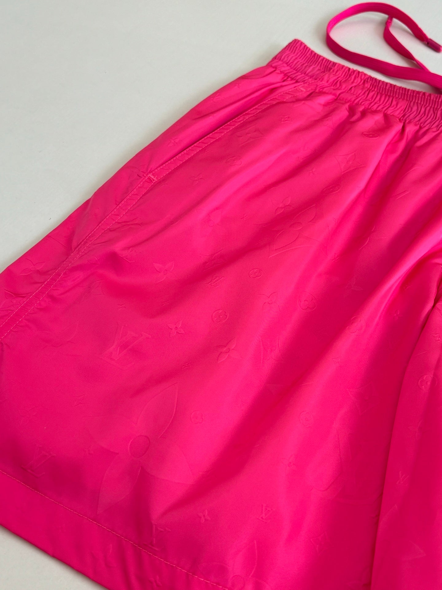 Hot pink shorts fabric with elastic waistband and curved side panel seams