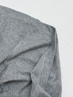 Grey T-shirt side seam with visible stitching detail