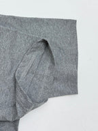 Grey T-shirt sleeve with stitched seam and folded hem
