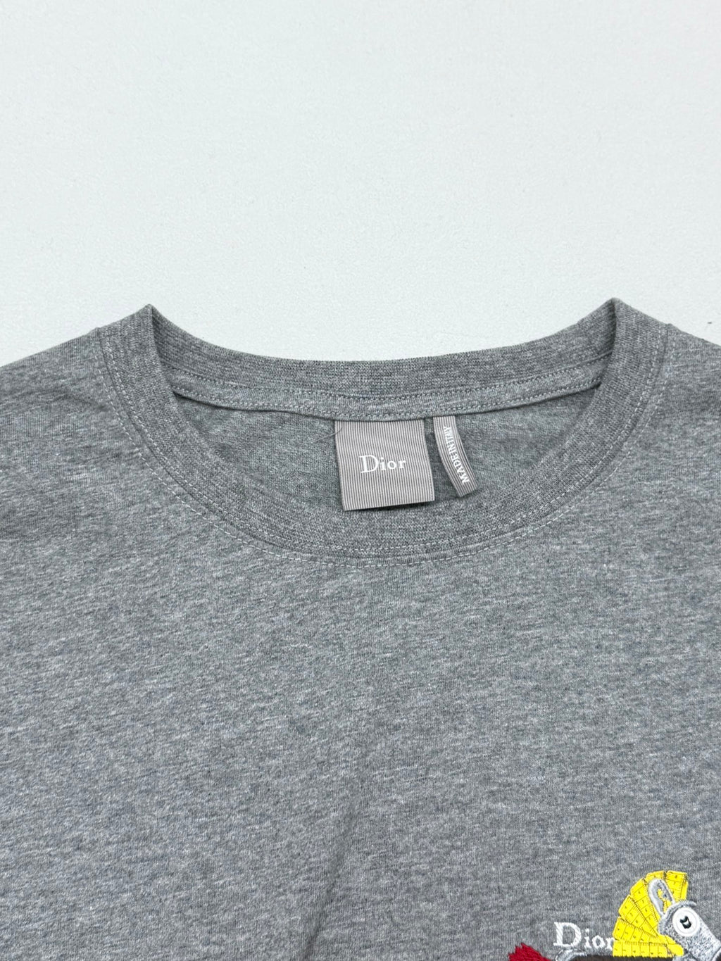 Grey crew-neck T-shirt collar with brand neck label