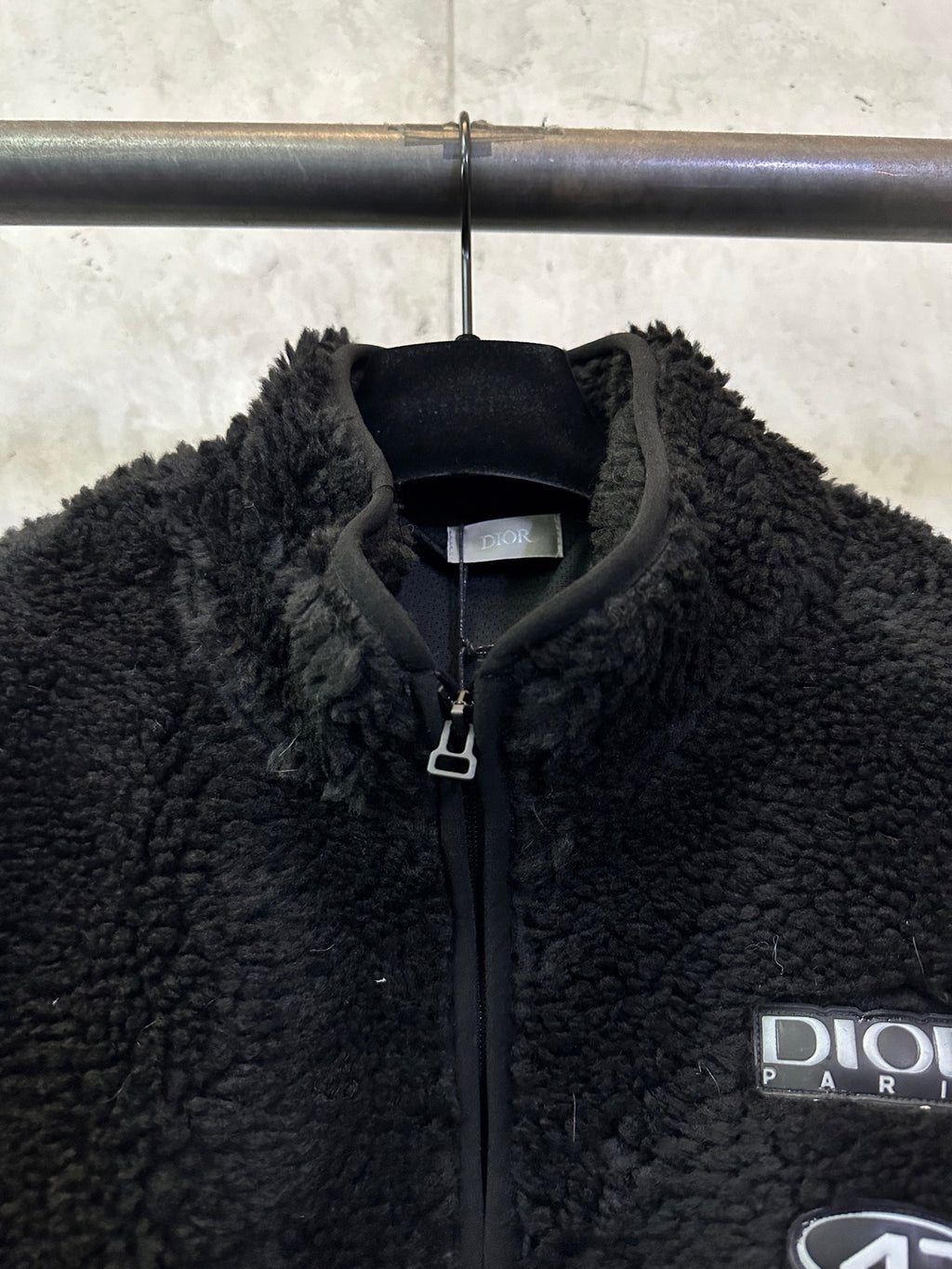 Dior black fleece jacket close-up, full-zip collar and logo patch