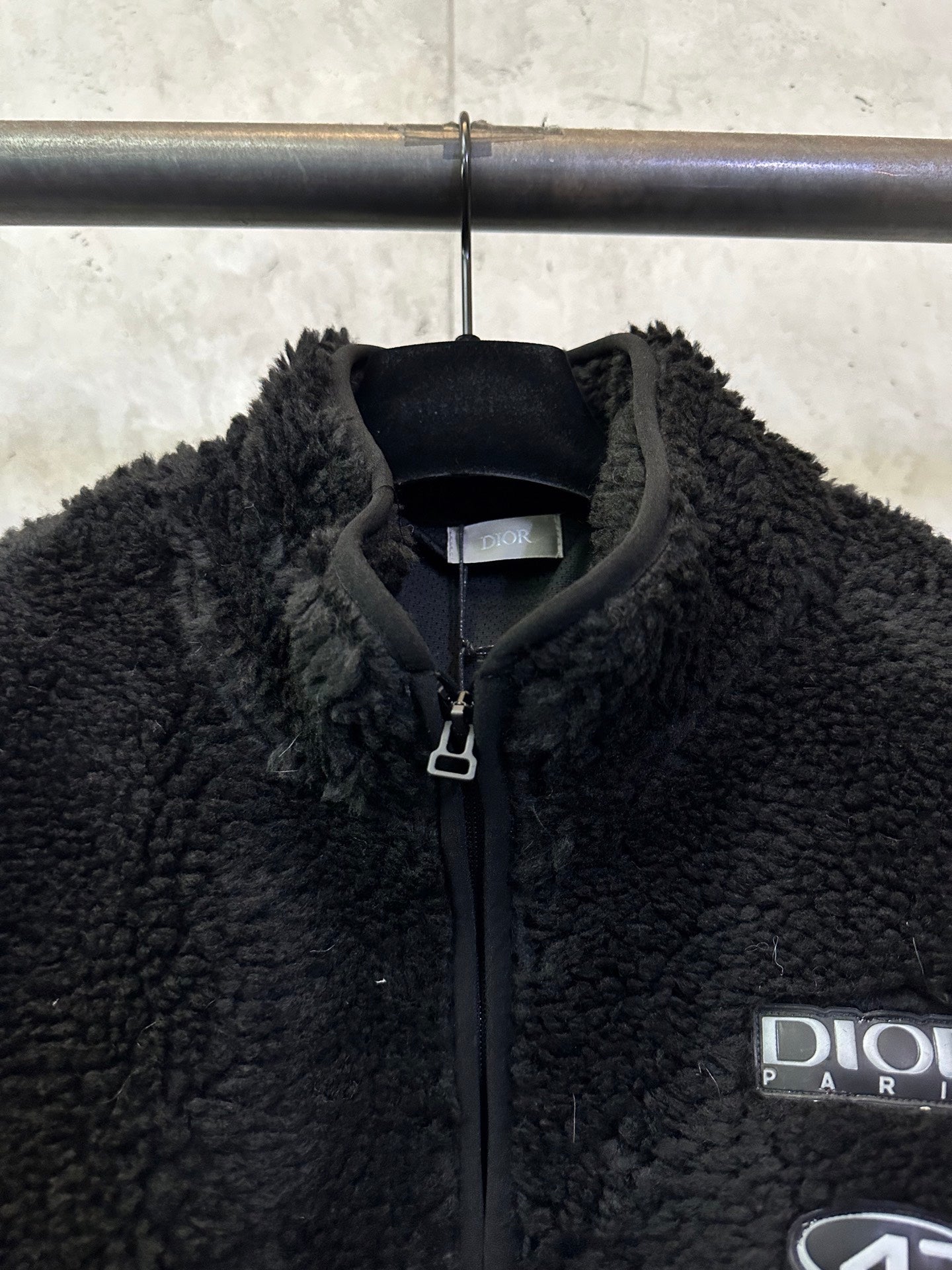 Dior black fleece jacket close-up, full-zip collar and logo patch