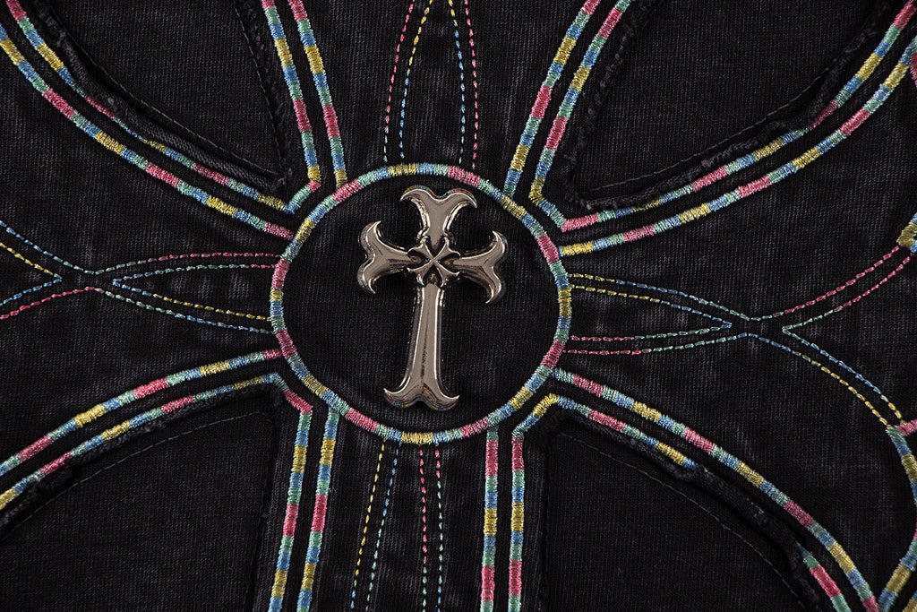 Close-up of circular cross emblem with multicolor stitching on black T-shirt