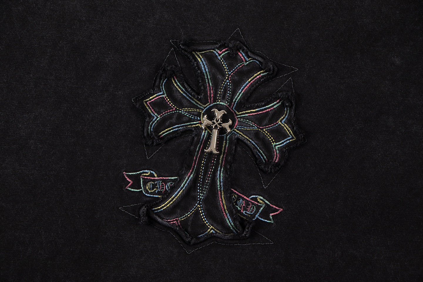 Close-up of cross-flower emblem graphic on black T-shirt