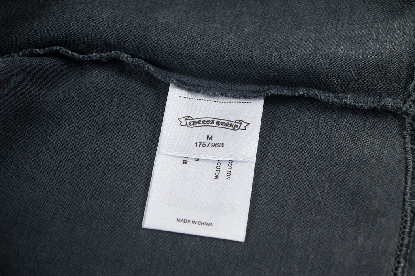 Dark T-shirt inner neck label with size M and made in China
