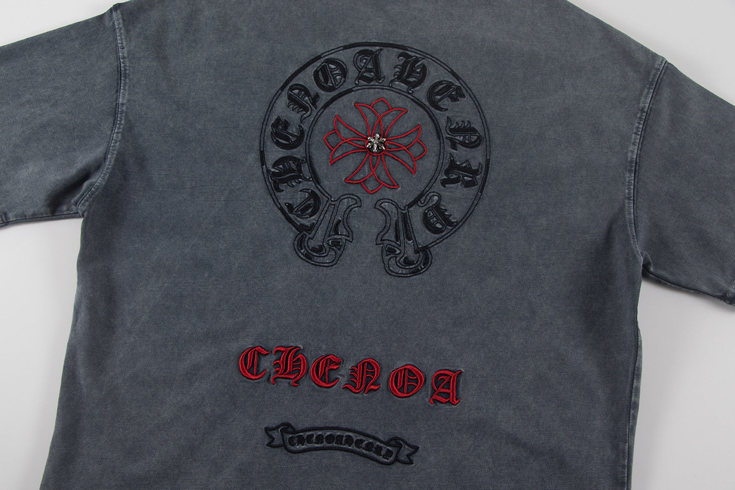 Charcoal short-sleeve T-shirt back with circular skull-and-flower and CHENOA text