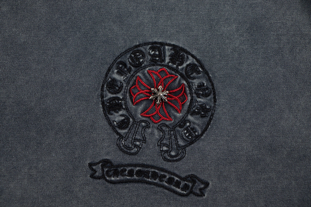 Charcoal T-shirt chest logo: circular skull graphic with red flower and text