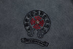 Charcoal T-shirt chest logo: circular skull graphic with red flower and text