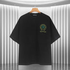 Black graphic T-shirt with small chest emblem and teal-and-gold logo print