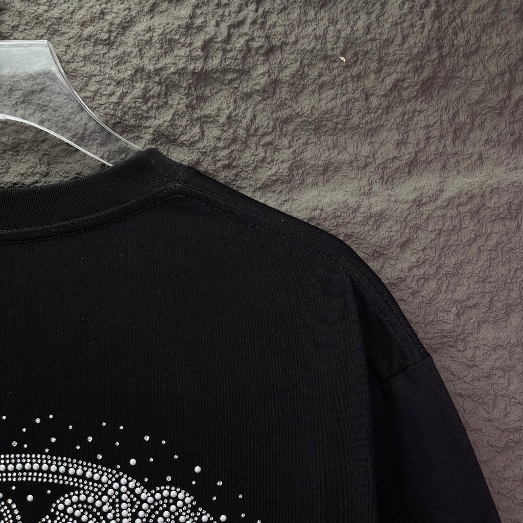 Black T-shirt with rhinestone design near lower back hem area