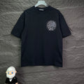 Black short-sleeve T-shirt with small circular rhinestone crest on chest