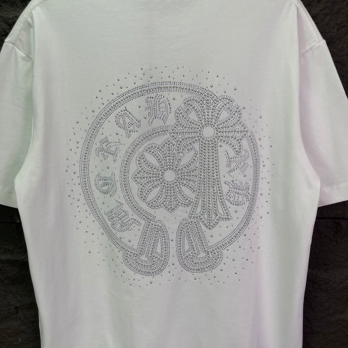 White short-sleeve T-shirt with large rhinestone emblem on the back