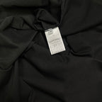Black T-shirt fabric close-up with white size label