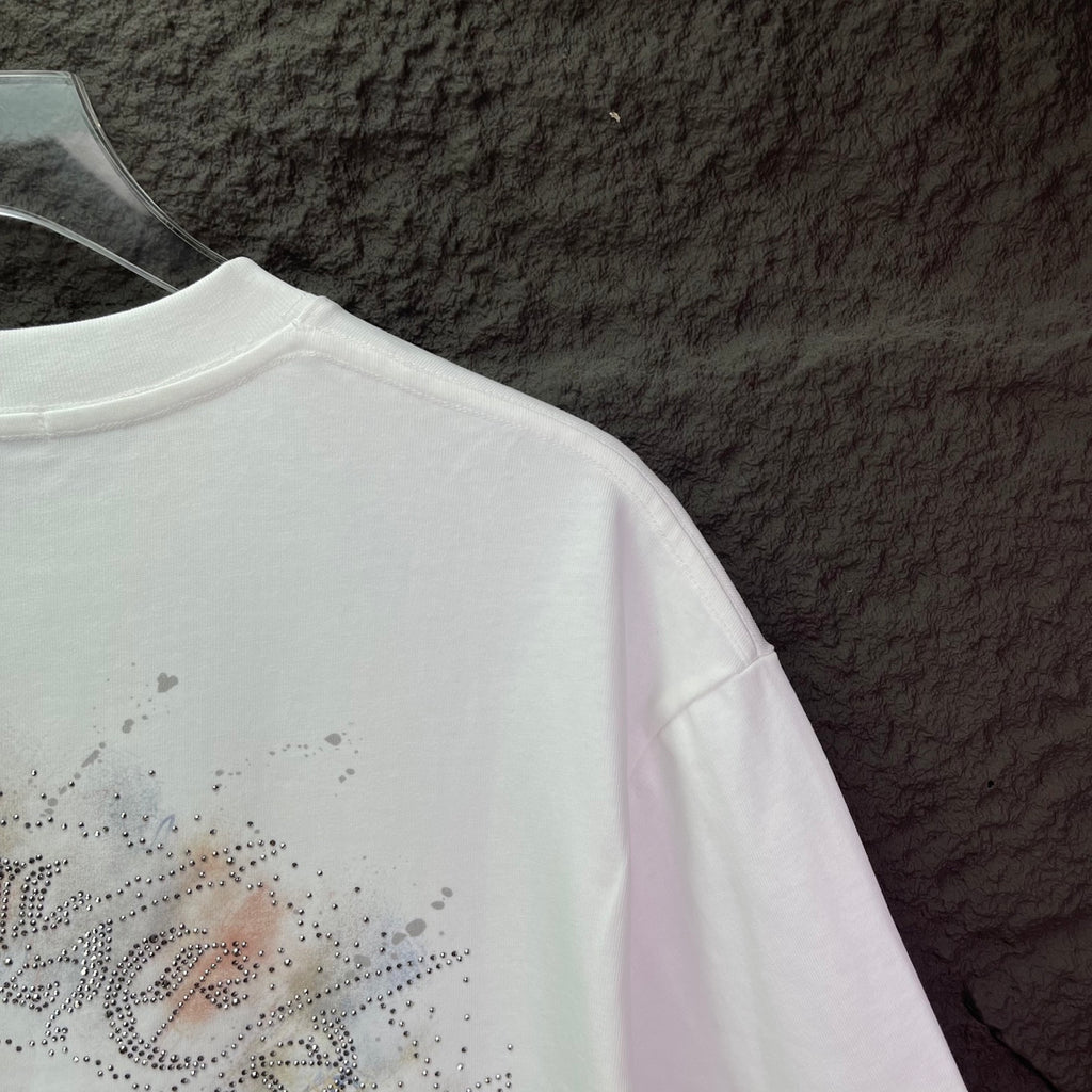 White T-shirt sleeve and back detail with rhinestone script graphic
