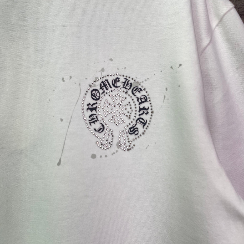 White T-shirt with round rhinestone crest graphic at chest