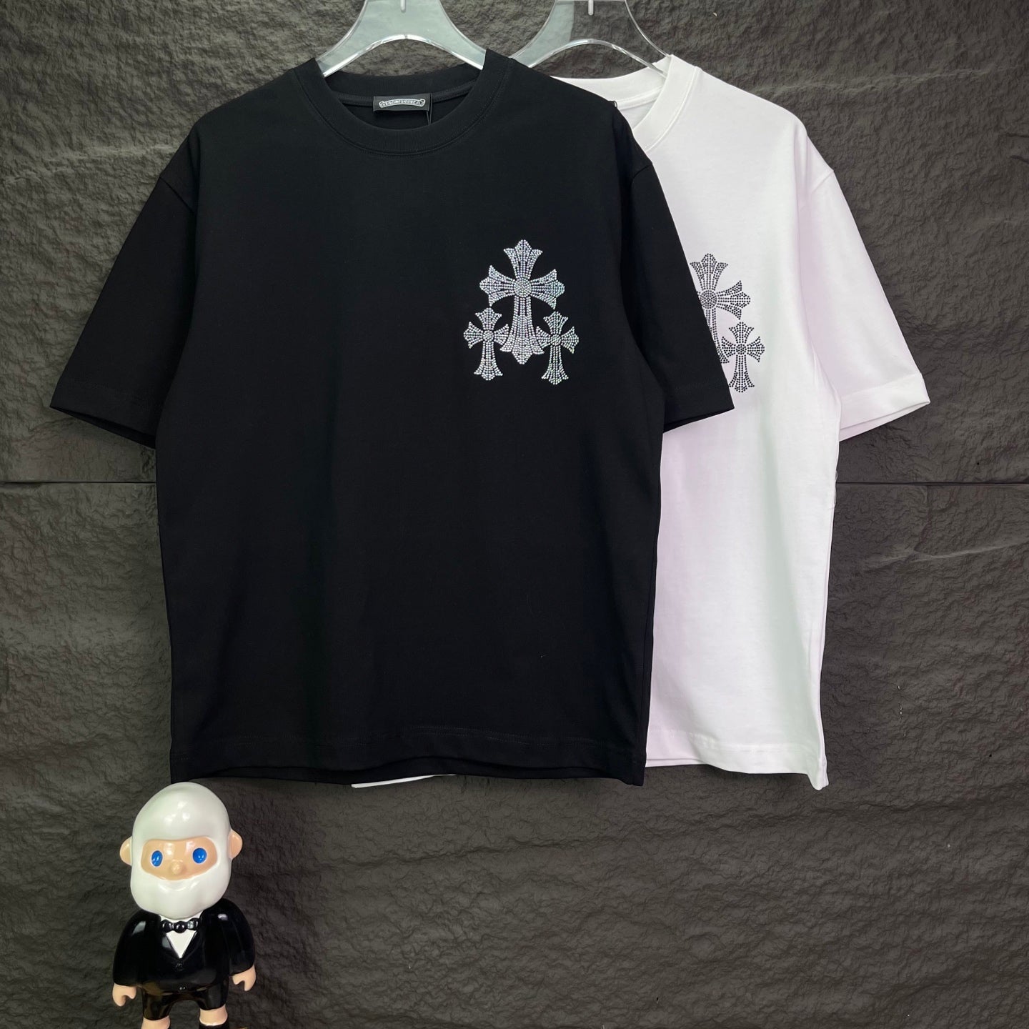 Black and white short-sleeve T-shirt with small cross logo on chest