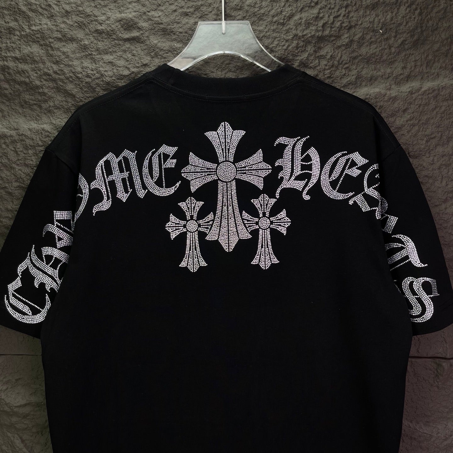 Black short-sleeve T-shirt with large rhinestone cross motif on back