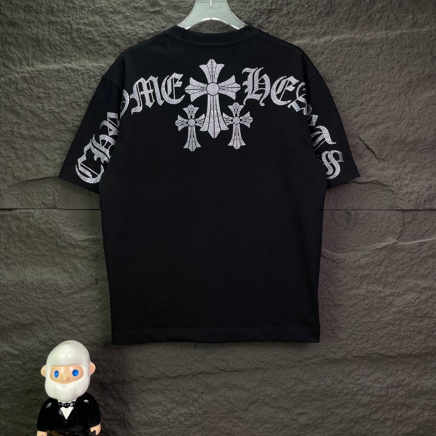 Black short-sleeve T-shirt with rhinestone cross motif across the back