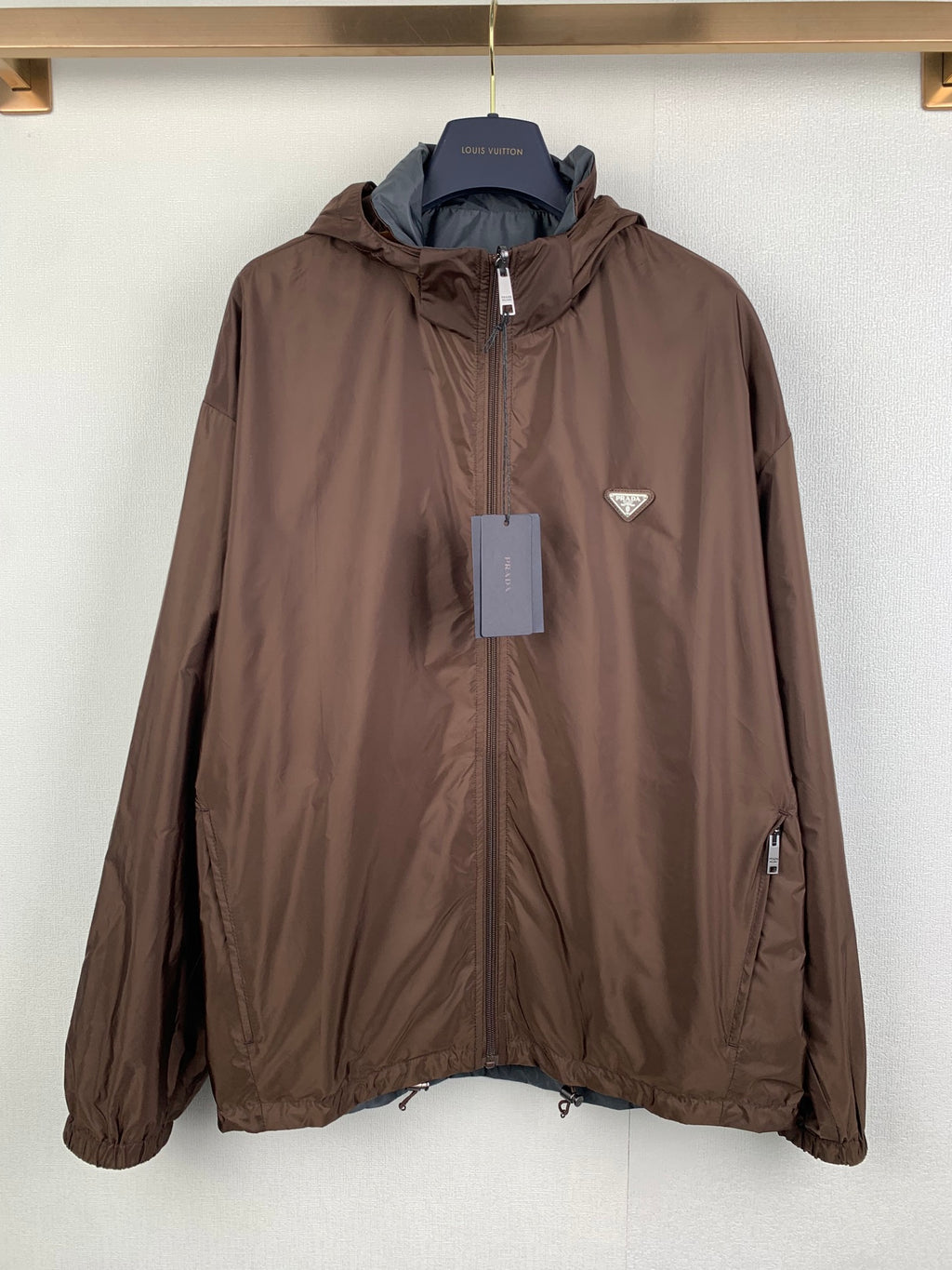 Brown long zip-up hooded jacket with logo triangle chest patch