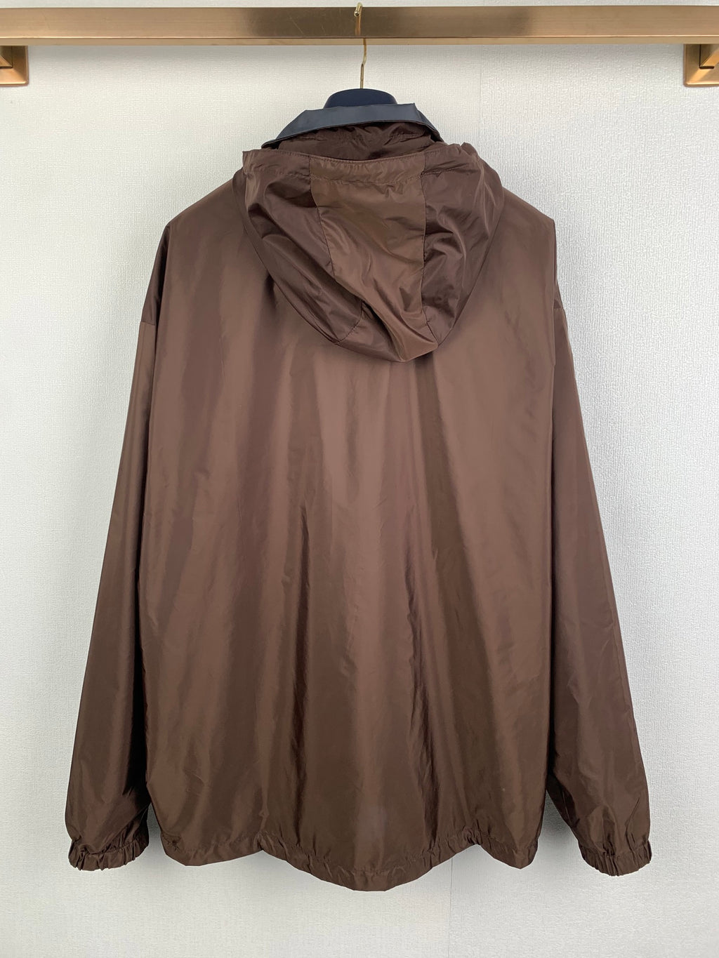 Brown long hooded windbreaker jacket, rear view with hood