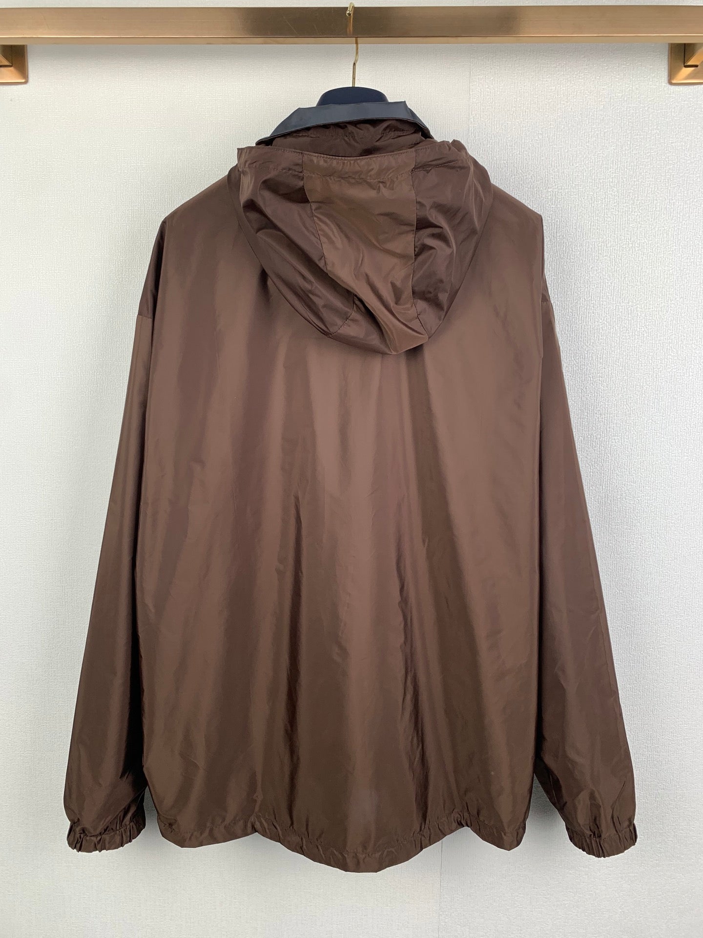 Brown long hooded windbreaker jacket, rear view with hood