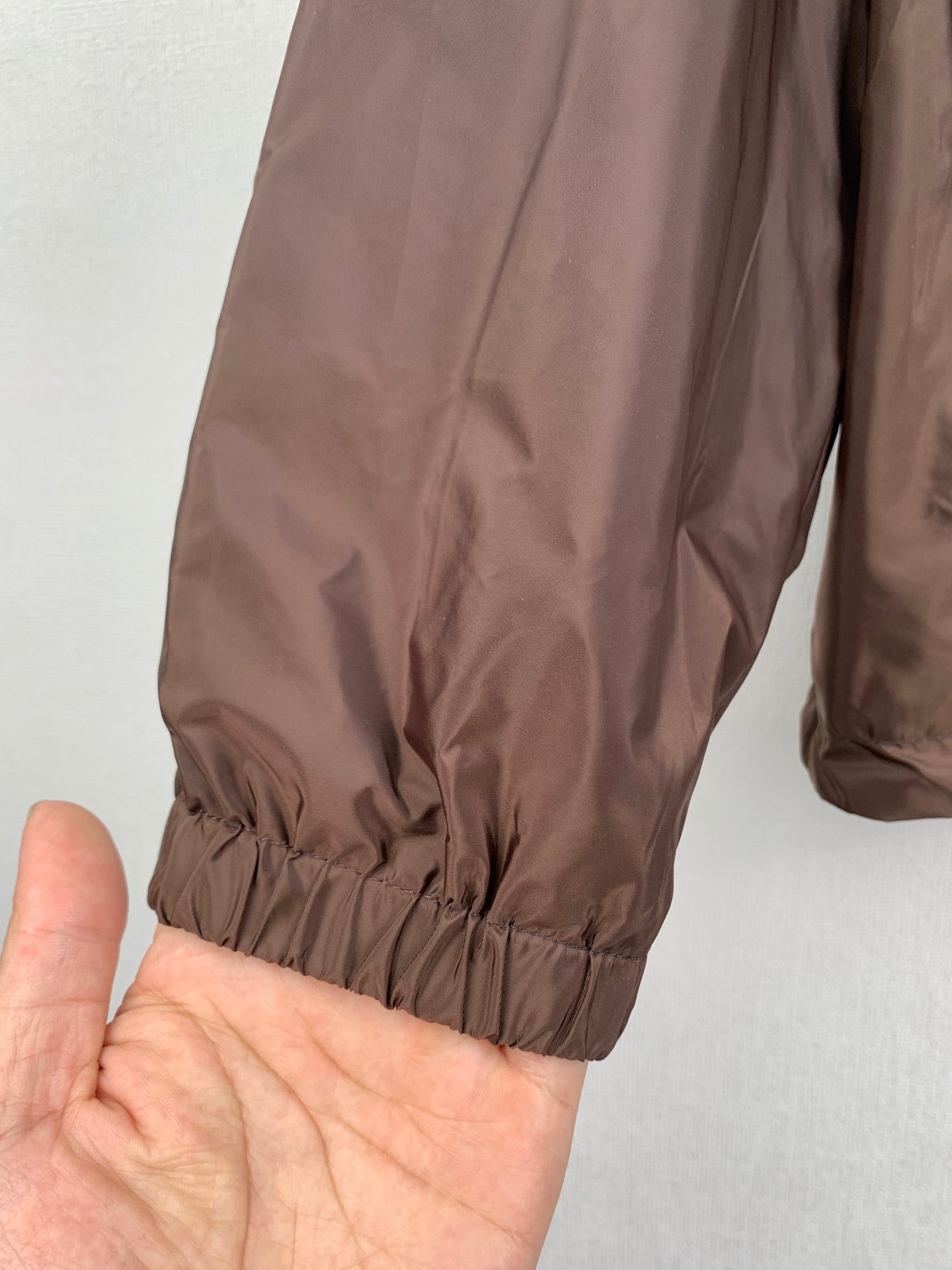 Brown jacket sleeve with elastic cuff and gathered hem