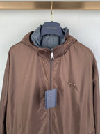Brown hooded zip jacket with small chest logo and hanging tag