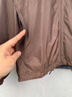 Brown jacket close-up with side zipper and inner seam