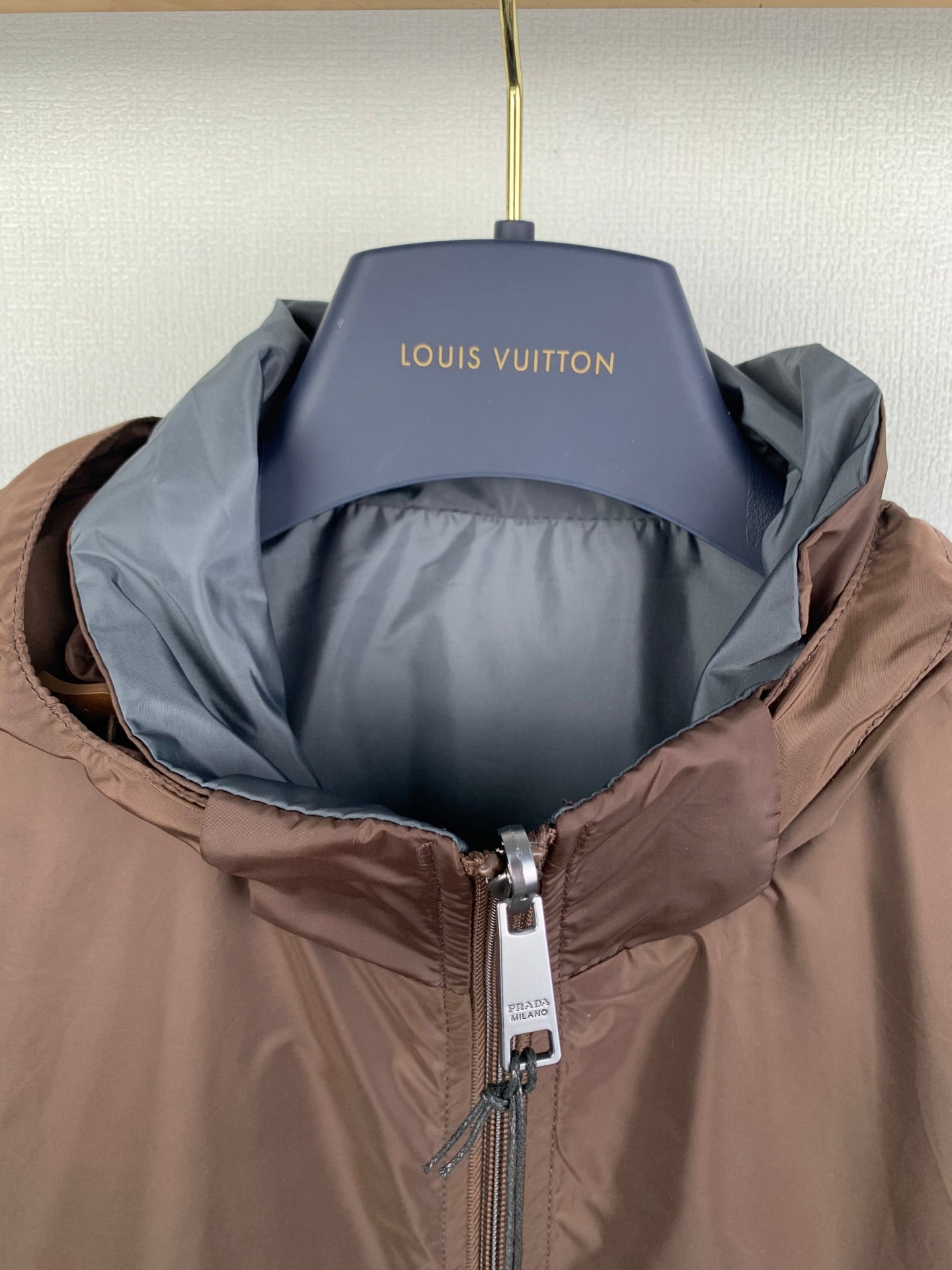 Brown hooded zip jacket open, showing dark interior lining