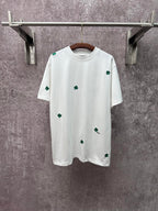 White short-sleeve T-shirt with green clover embroidery, crew neckline